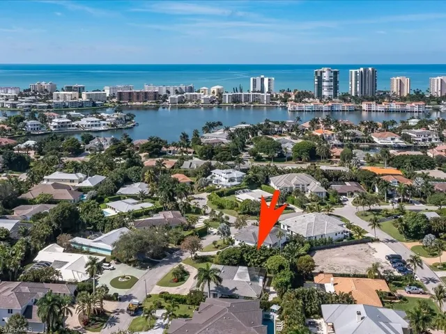 Aerial overview of property's location with a nearby body of water and nearby urban area