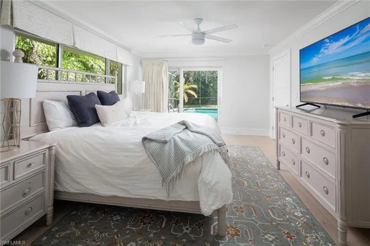 Bedroom featuring ornamental molding, light wood finished floors, ceiling fan, and access to outside