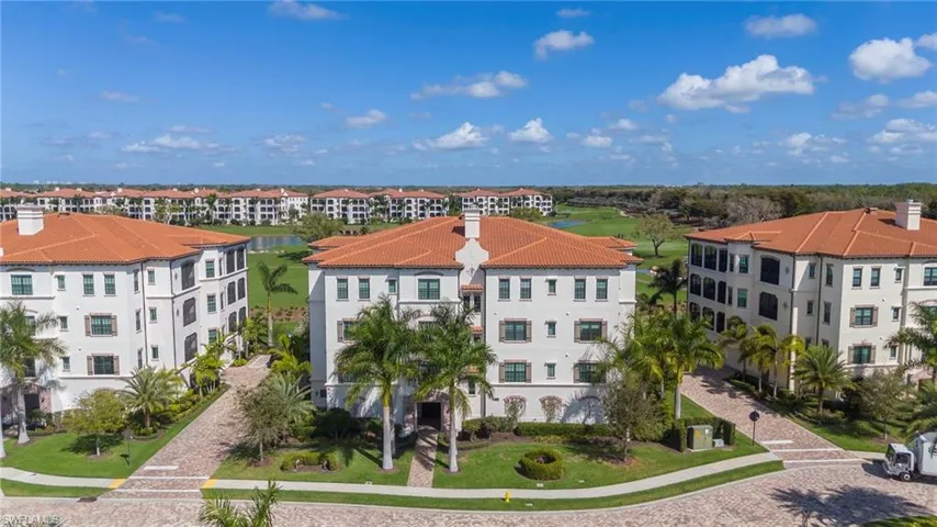 Aerial view of apartment complex and a large body of water