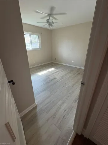 Spare room featuring light wood finished floors and a ceiling fan