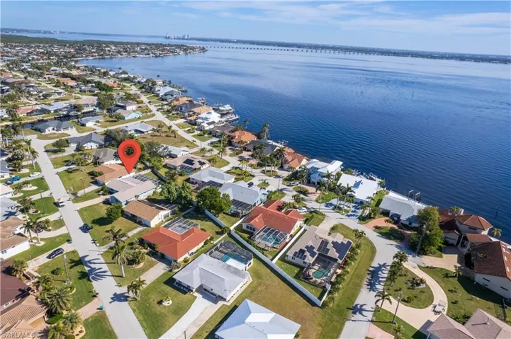 Birds eye view of property with a water view and a residential view