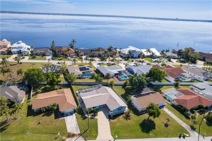 Drone / aerial view with a water view and a residential view