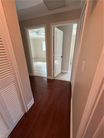 Hall with baseboards and dark wood finished floors
