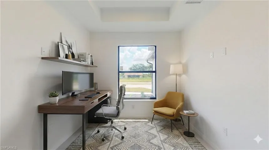 Office area featuring a tray ceiling and baseboards