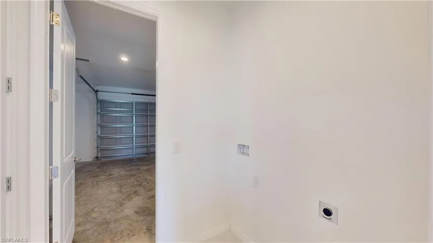 Laundry area featuring a garage, recessed lighting, and electric dryer hookup