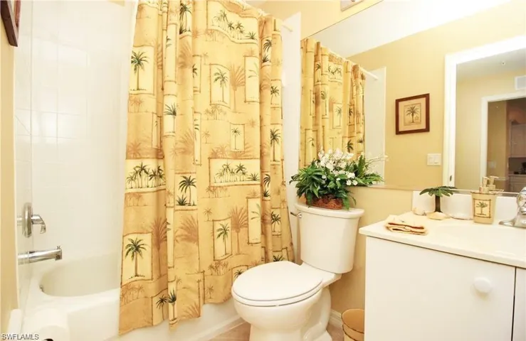 Full bathroom with vanity, toilet, and shower / tub combo with curtain