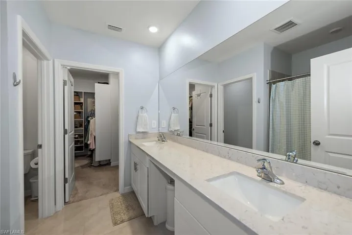 Primary bathroom features a double sink vanity