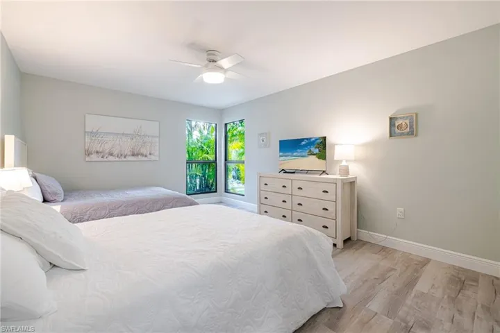 Bedroom with light wood-style floors and a ceiling fan