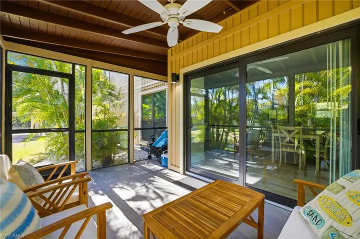 Sunroom / solarium featuring a wooden ceiling with exposed beams