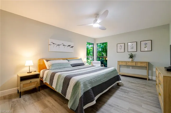 Primary Bedroom with light wood-style flooring and a ceiling fan