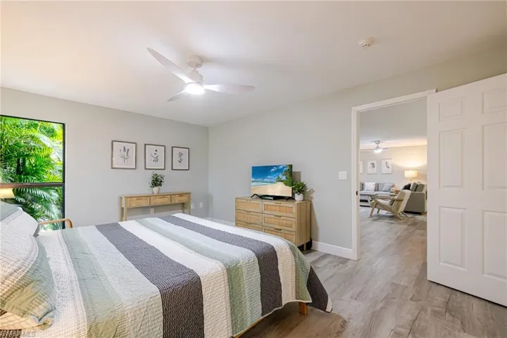 Primary Bedroom with light wood-style flooring and ceiling fan