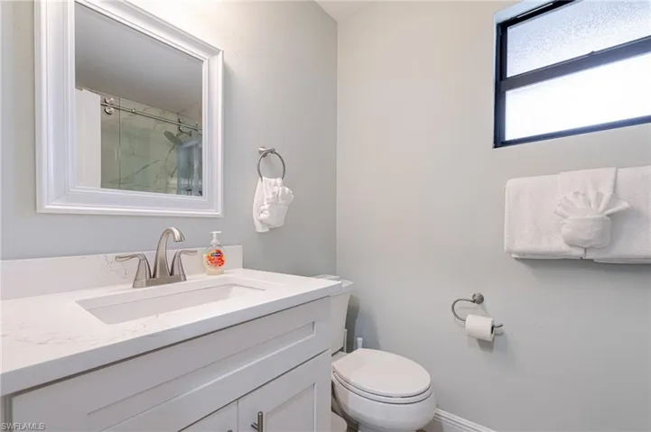 Bathroom with curtained shower and vanity