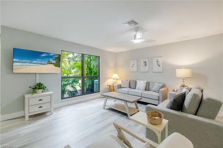 Living room featuring ceiling fan and light wood-style floors