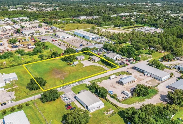 Aerial view of property and surrounding area with property parcel outlined