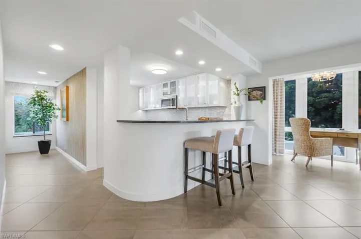A beautiful bright entry with warm-toned Wallcovering sets a classic tone