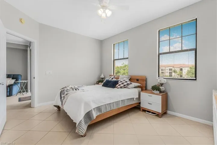 Bedroom featuring light tile patterned flooring and ceiling fan