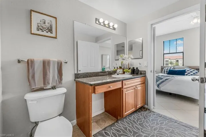 Bathroom with vanity, ensuite bath, and tile patterned floors