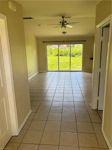 Spare room featuring light tile patterned floors and ceiling fan