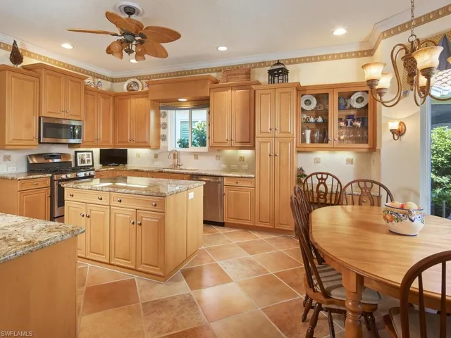 Kitchen...natural gas range, center island, stainless steel appliances, large pantry, planning desk and breakfast nook to right. Light and bright.