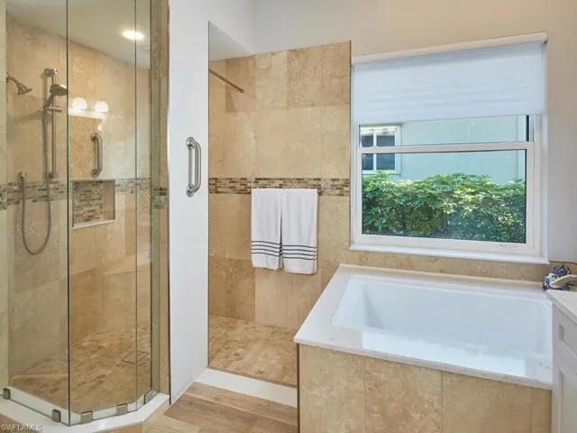 Master Bath walk-in, frameless glass enclosed shower and tub to right.