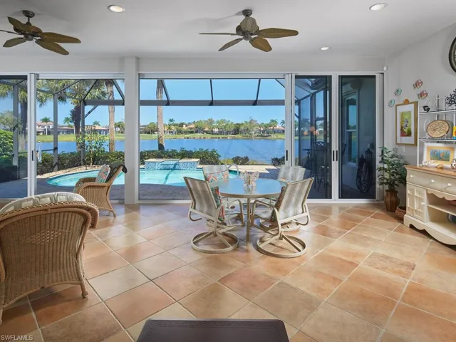 Florida Room looking from Great Room to lanai, pool and lake beyond. Private, quiet and serene.