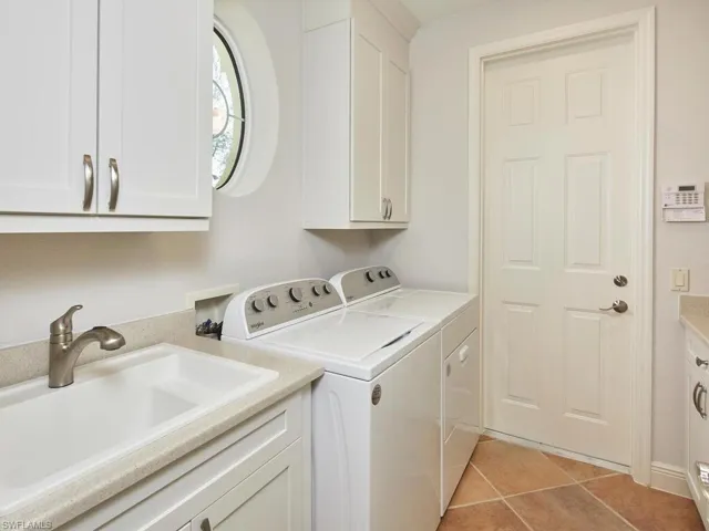 Utility Room, new washer and dryer 2022, laundry tub to left, plenty of cabinet space. Door leads to 2-car garage.