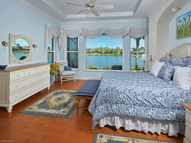 Master Bedroom, hardwood floors in all bedrooms, new custom hurricane strength impact resistant windows..note unobstructed bay window with lake view. Tray ceiling and two California custom walk-in closets.
