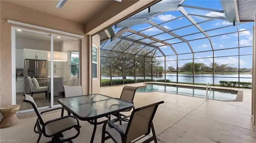 View of patio / terrace featuring glass enclosure and a water view