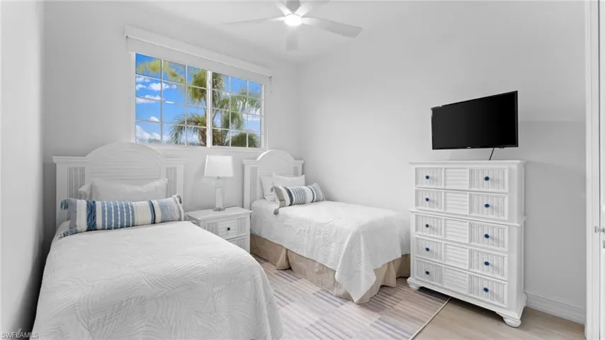 Bedroom with ceiling fan and light wood-type flooring