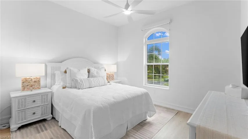 Bedroom with light hardwood / wood-style floors and ceiling fan