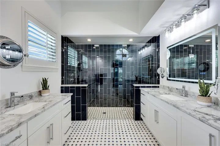 Ensuite primary bathroom has been tastefully updated - featuring a spacious walk-in shower and dual vanities.
