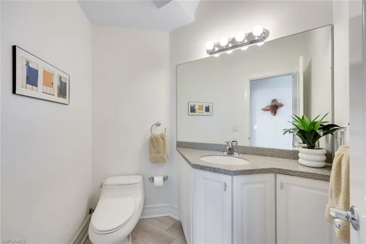 Powder room is conveniently located just off the living area.