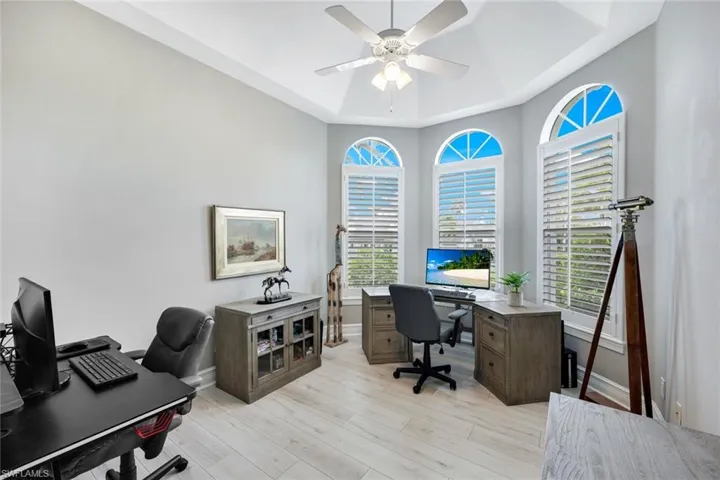 Plantation shutters and plenty of sunlight adorn the den/office space; pure perfection!
