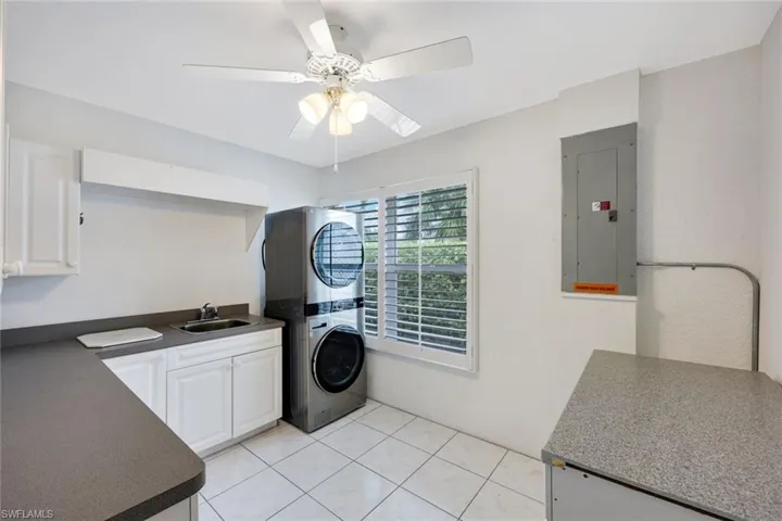 HUGE laundry room features a laundry tub and plenty of additional storage.