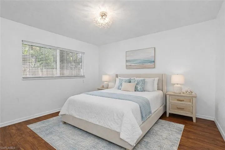 Bedroom featuring baseboards and dark wood-style floors