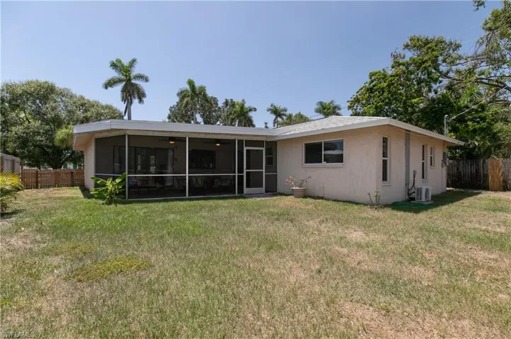 Back of property with stucco siding, a sunroom, and a ceiling fan
