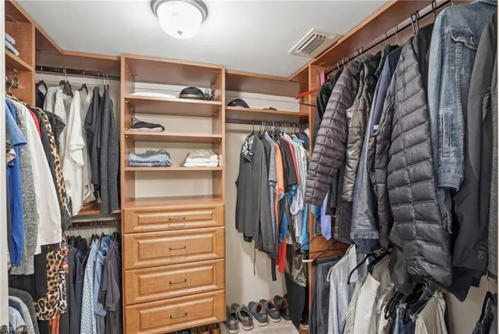 Walk in closet with custom shelving
