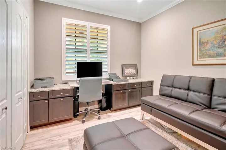 Office space featuring crown molding and light hardwood / wood-style floors