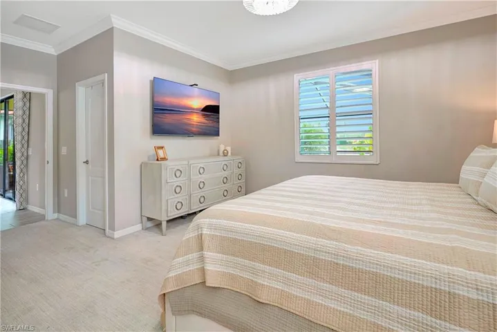 Carpeted bedroom with crown molding