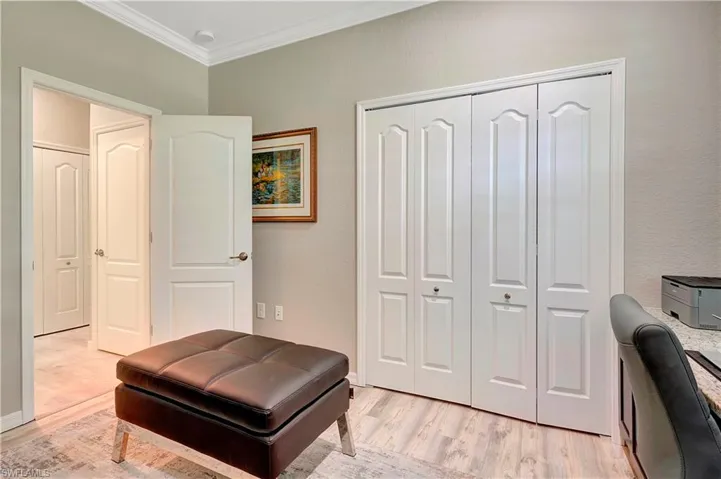 Living area featuring light hardwood / wood-style floors and ornamental molding