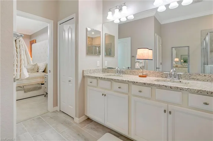 Bathroom featuring ornamental molding, tile patterned flooring, and double sink vanity