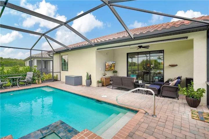 View of pool featuring outdoor lounge area, a patio, ceiling fan, and a lanai