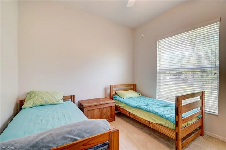 Bedroom with ceiling fan and carpet floors