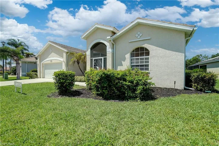 View of front of house with a garage and a front yard