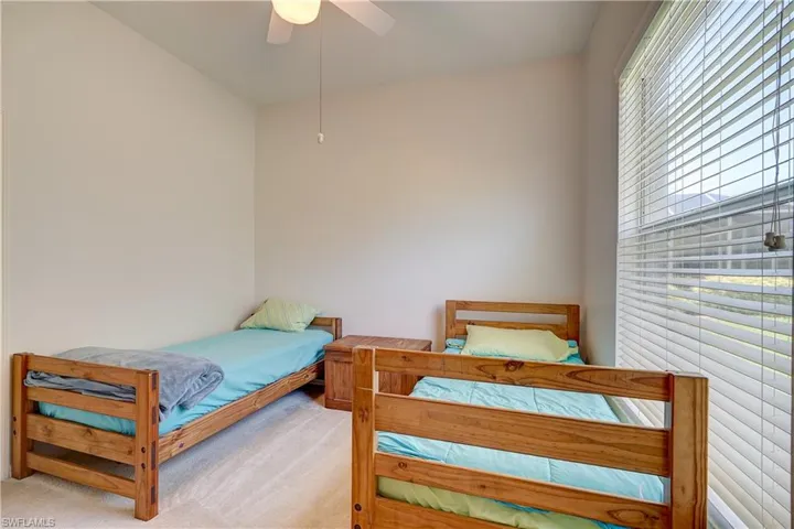 Carpeted bedroom with ceiling fan