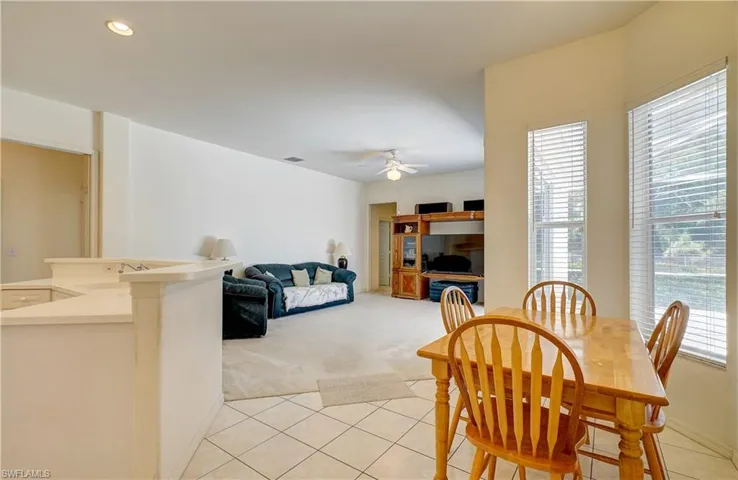 Dining room featuring sink, ceiling fan, and light tile floors