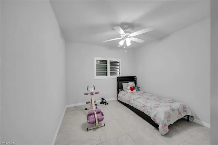 Bedroom featuring baseboards and ceiling fan