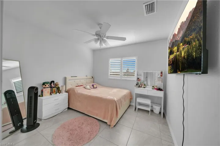 Bedroom featuring ceiling fan and tile patterned flooring