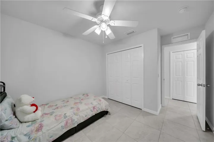 Bedroom featuring a ceiling fan and a closet