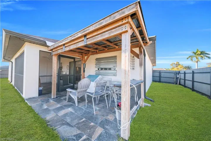 Fenced backyard with a patio